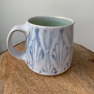 Katy Drijber porcelain pottery mug with blue and white drippy glaze pattern in Fernie, BC - a handcrafted gift for coffee lovers