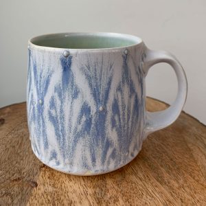 Katy Drijber porcelain pottery mug with blue and white drippy glaze pattern in Fernie, BC - a handcrafted gift for coffee lovers