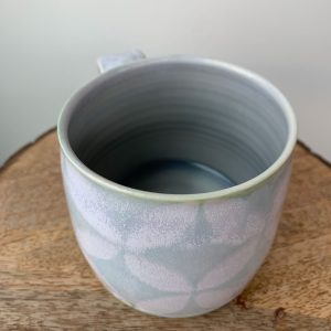 wheel thrown porcelain mug by Alberta potter Katy Drijber snowflake or floral pattern in green