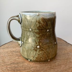 porcelain wheel thrown mug by Katy Drijber with a green glaze, floral decal pattern and two gold foil owls with handle - back