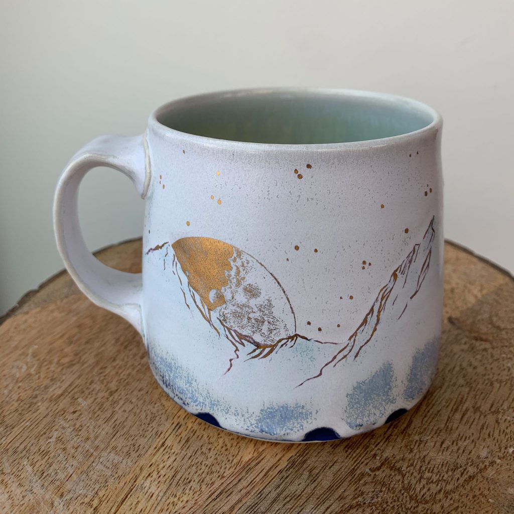 katy drijber 2023 porcelain coffee or tea mug with mountain, moon, and tree landscape gold foil details