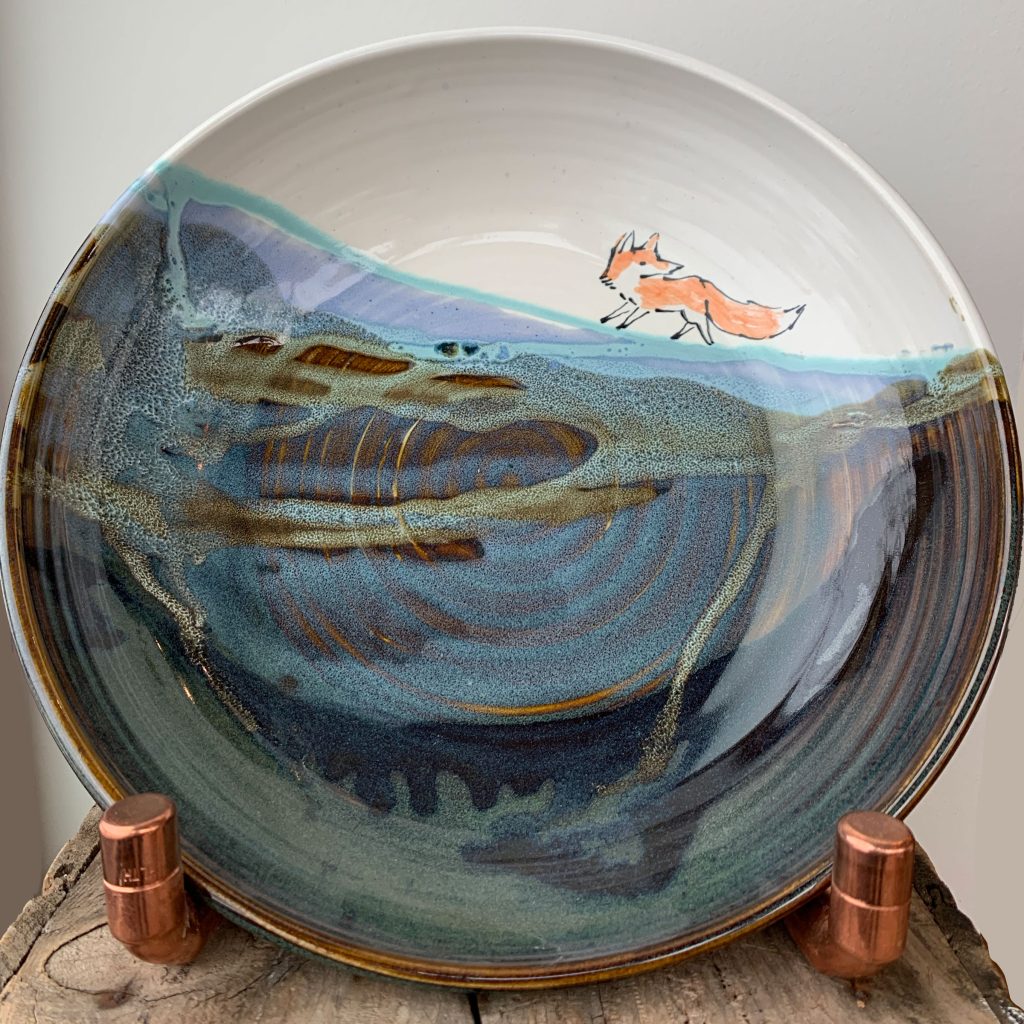 Bronwyn Arundel's pottery serving bowl with her signature landscape and running fox