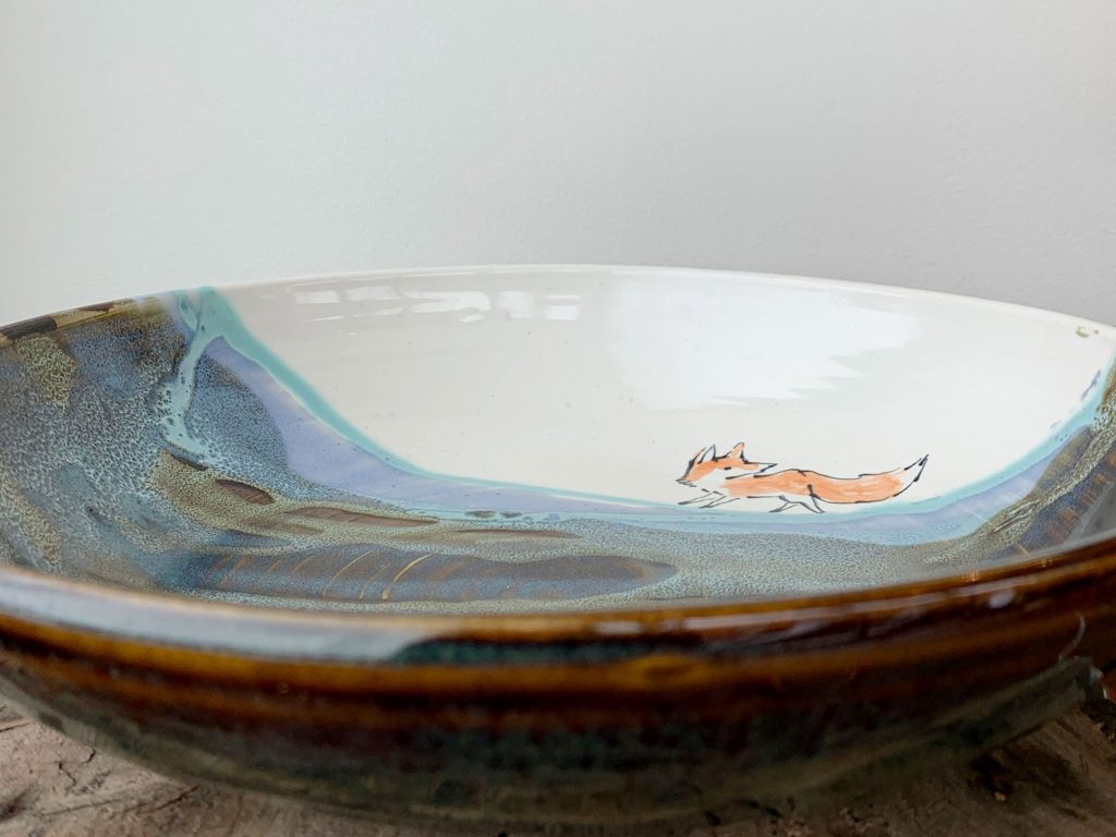 Bronwyn Arundel landscape with a running fox plate - pottery made in Canada