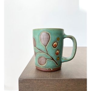 Juliana Rempel's Green Leaf and Berries ceramic mug by Calgary potter at h squared gallery in Fernie