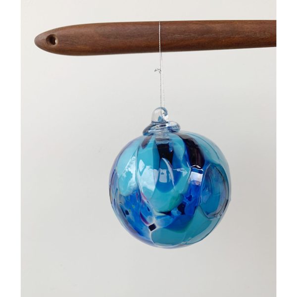 Leah Petrucci's blown glass sun catcher ornaments in blues at h squared art gallery in Fernie, home to artists and makers from across Canada