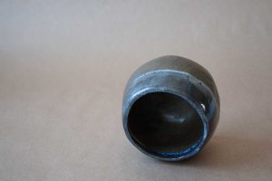 blue glaze on black clay minimalist bowl by This and That potter Steve Cho in Fernie, BC