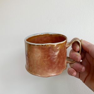 Heather Dynes Smit, hand built potter and wood fired ceramic mug with salmon and pink hues