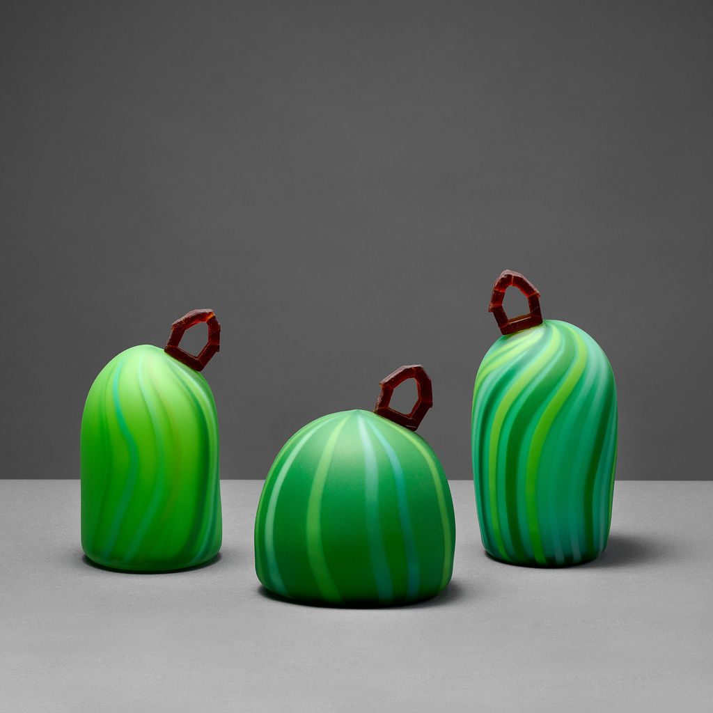 glass sculpture of home on a green hill by Leah Petrucci, Calgary artist at h squared gallery in Fernie, BC