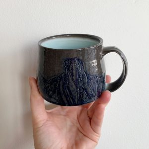 Topo Pots skyline mug dark brown and blue with light blue glass interior at Fernie's best Canadian pottery shop h squared gallery