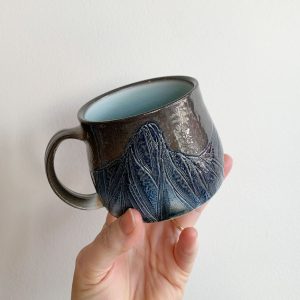 Topo Pots skyline mug dark brown and blue with light blue glass interior at Fernie's best Canadian pottery shop h squared gallery